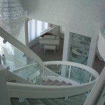 Curved and etched decorative glass elements to a staircase