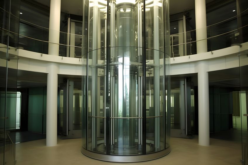 Glass tubular elevator in modern building